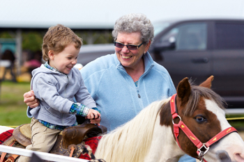 Boy Rides A Pony At A Fair